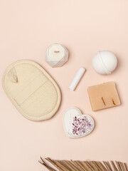 Set of natural cosmetics on pink background. Bath bomb, soap, candle, washcloth and lip balm