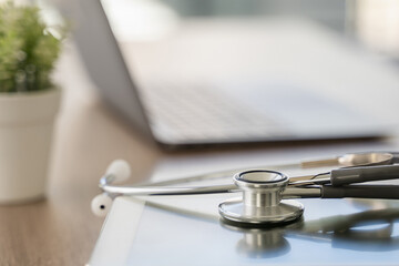 stethoscope computer and background doctor using laptop at desk medical network on Computing...