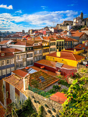View of the rooftops of the city of Porto, Portugal. Tiled roofs just sparkle against the sky.