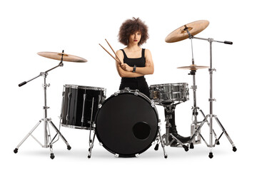 Fototapeta premium Female drummer sitting and holding drumsticks