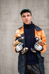 Young construction worker outdoors. Renovation background.