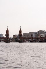 Fototapeta premium Berlin Oberbaumbrücke bridge connecting two parts of the city over the river, tourist attraction - tourism concept