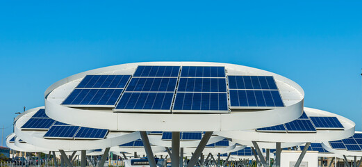 solar power plant with big antennas on a parking for charging electrocars, car energy of future