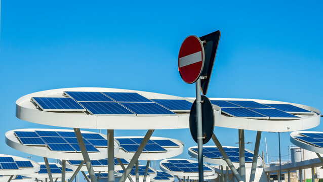 solar power plant with big antennas on a parking for charging electrocars, problems of car energy of future