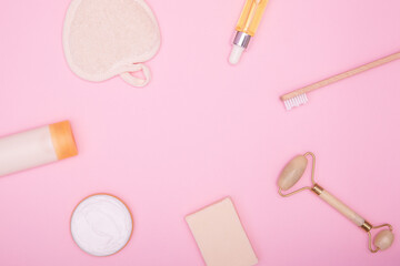 Frame from cosmetic products and hygiene items on a pink background. Beauty background. The concept of face and body care. copy space, flat lay.