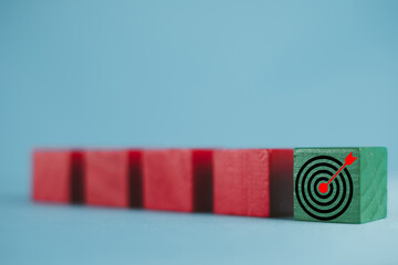 Selective focus on Green Wooden Cube with Target board icon use for Challenge,Strategy,Focus,Target,objective business concept.,