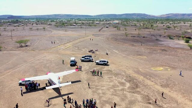 drone of airplane airport runway after planes have landed with people barding