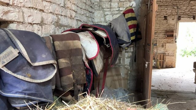 Horse saddles and equipment in the stable
