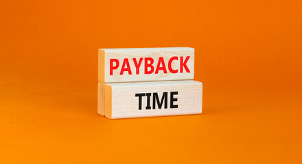 Payback time symbol. Concept words Payback time on wooden blocks. Beautiful orange table orange background. Business and payback time concept. Copy space.