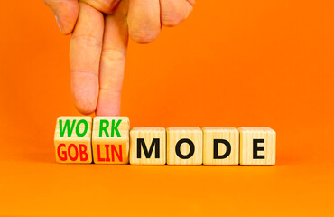 Work or goblin mode symbol. Concept word Work mode Goblin mode on wooden cubes. Businessman hand....