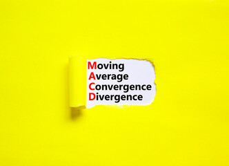 MACD symbol. Concept words MACD moving average convergence divergence on white paper on beautiful yellow background. Business MACD moving average convergence divergence concept. Copy space.