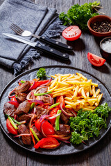Lomo saltado, fried beef, french fries, veggies