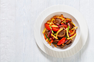 Lomo saltado, fried beef, french fries, veggies
