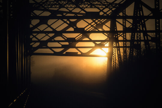 Silhouettes of girders of bridge at dusk