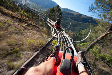 Two men ride the Alpine Coaster above Glenwood Springs at Glenwood Caverns Adventure Park, CO.
