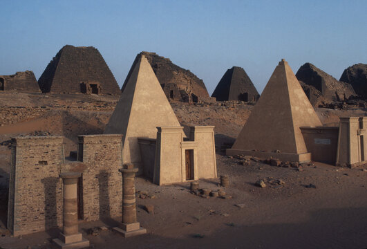 Pyramids line a river shore, Sudan.