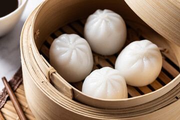 Steamed dumplings on white marble background. Traditional oriental food. Close up