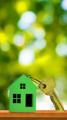Keys and keychain in the form of a house on a table