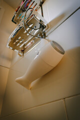 bathroom details with hair dryer hanging