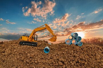 Crawler excavators digging water pipes at construction site and  lift up bucket on blue sky with...