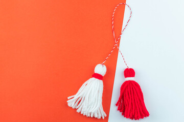 Traditional Martisor - symbol of holiday 1 March, Martenitsa, Baba Marta, beginning of spring and seasons changing in Romania, Bulgaria, Moldova. Greeting and post card for holidays.