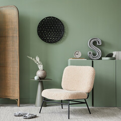 Creative living room interior composition with frotte armchair, folding screen, wooden commode and...