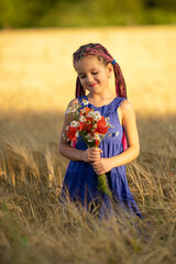 A six-year-old girl in a wheat field with a bouquet of flowers.