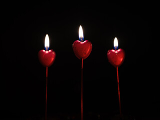 Red burning heart shaped candles