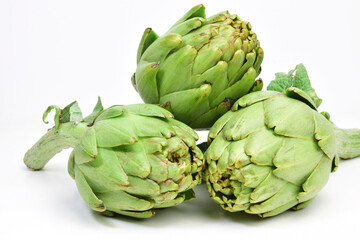 Group artichokes, natural, light background and copy space.
