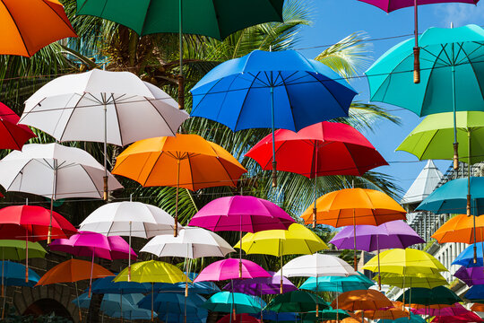Colorful umbrellas spanning street at Caudan Waterfront shopping center, Port Louis, Mauritius