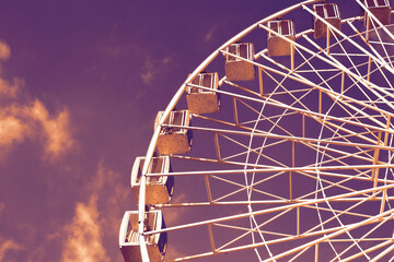 Ferris wheel against purple sky