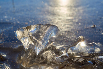 a macro piece of ice on the background of a winter lake