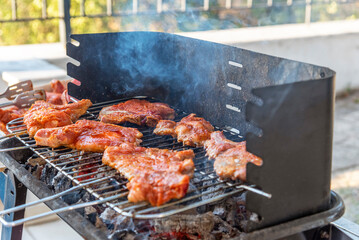 BBQ ribs. Ribs fried over an open fire. Fire and smoke roll meat.