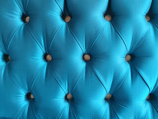headboard upholstered in turquoise blue fabric with decorative buttons