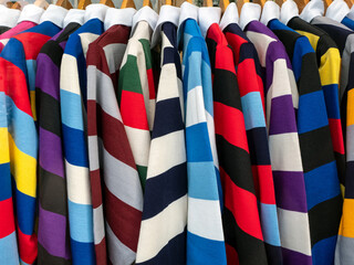 CAMBRIDGE, UK - MARCH 11, 2020:   Colourful striped College Rugby Shirts  for Cambridge University hanging on display rail
