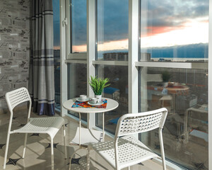 large spacious glazed balcony loggia in the apartment with a gorgeous view of the sunny city