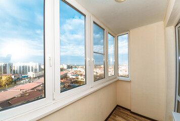 Fototapeta premium large spacious glazed balcony loggia in the apartment with a gorgeous view of the sunny city
