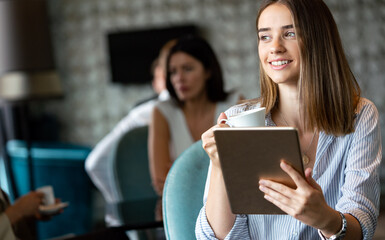 Young professional businesswoman sitting at table at cafe