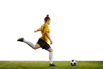 Fototapeta premium Winning goal. Young professional female football player in motion, training, playing football, soccer isolated over white background