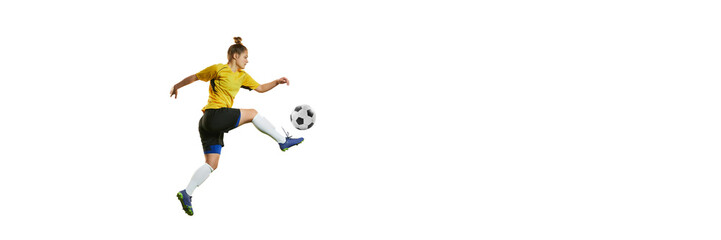 Young professional female football player in motion, training, playing football, soccer isolated over white background. Banner, flyer