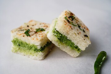 White Dhokla sandwich with green chutney, selective focus