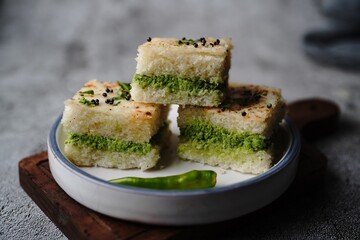 White Dhokla sandwich with green chutney, selective focus