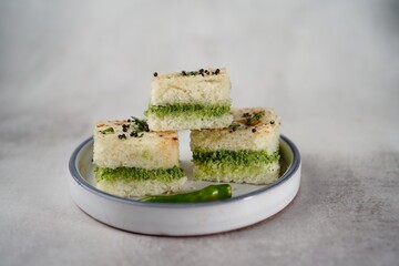 White Dhokla sandwich with green chutney, selective focus