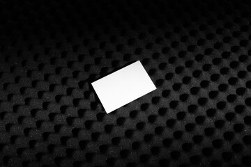 Branding business cards mockup template on a black soundproof foam background and deep shadows,...