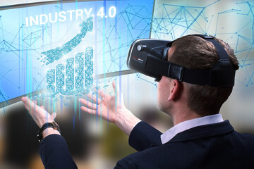 Business, Technology, Internet and network concept. Young businessman working on a virtual screen of the future and sees the inscription: Industry 4.0