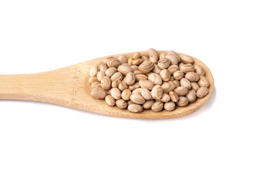 Brown beans on a spoon isolated over white background