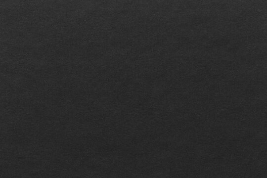 Black paper sheet texture cardboard background.
