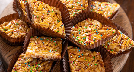 Desserts with almonds, peanuts and seeds in caramel. Traditional Sardinian sweet. Sweet squares....