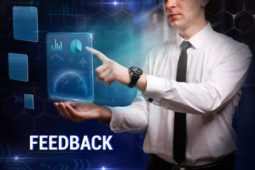 Business, Technology, Internet and network concept. Young businessman working on a virtual screen of the future and sees the inscription: Feedback