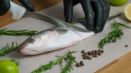 Mullet fish with marinade. Preparation the raw fresh fish for frying. Home kitchen, Culinary master class close-up